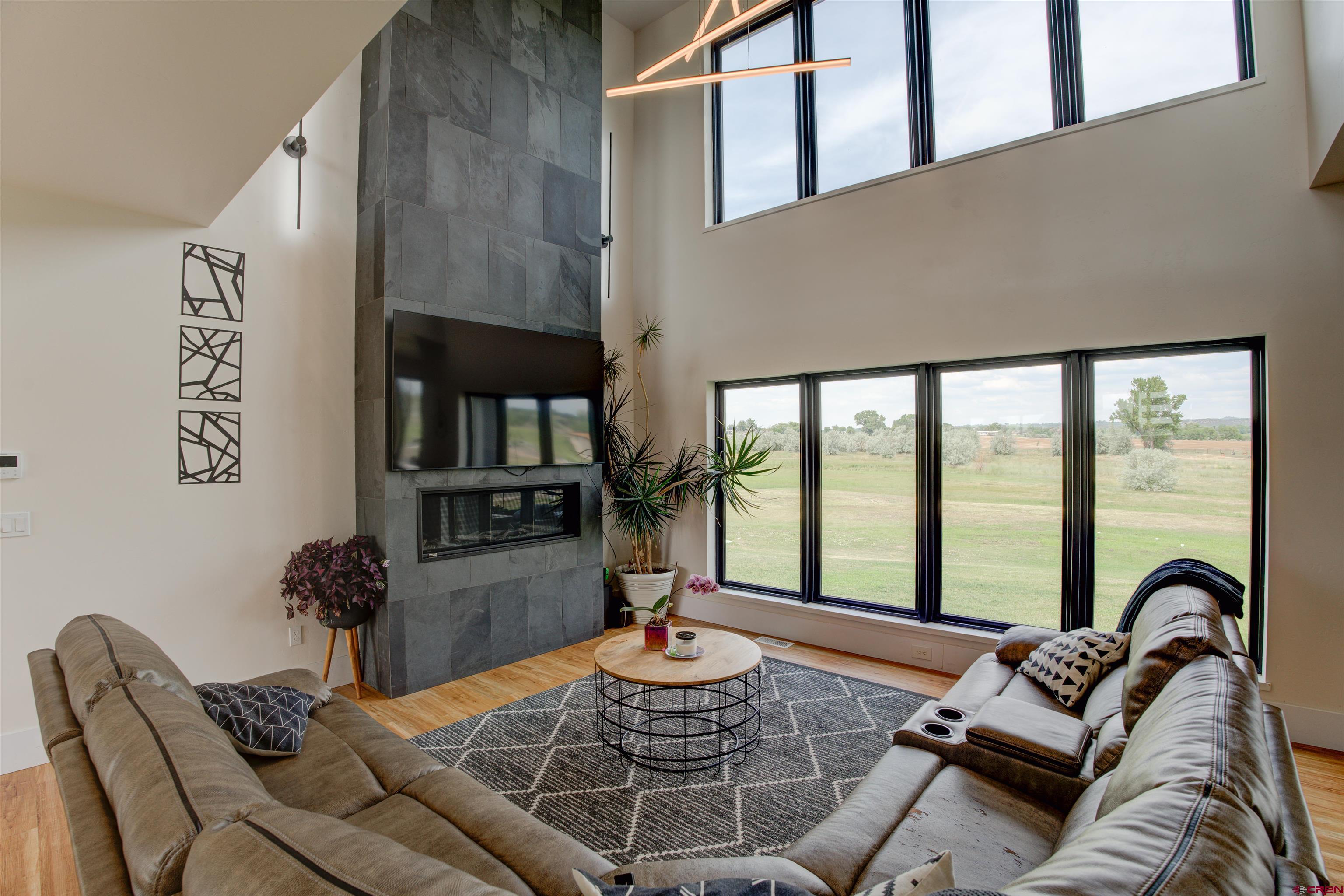 25320 Rd N.8 Loop Cortez, CO 81321 - Photo 10 of 40 a living room with furniture and a floor to ceiling window