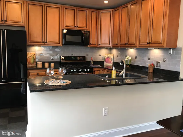 a kitchen with a sink a microwave and cabinets
