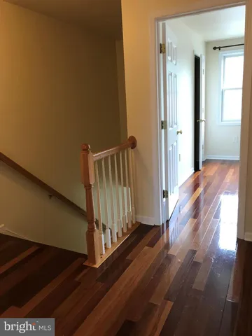 a view of a hallway view with wooden floor and staircase
