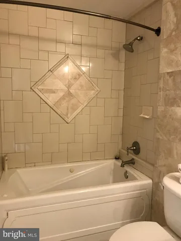 a bathroom with a bathtub and shower