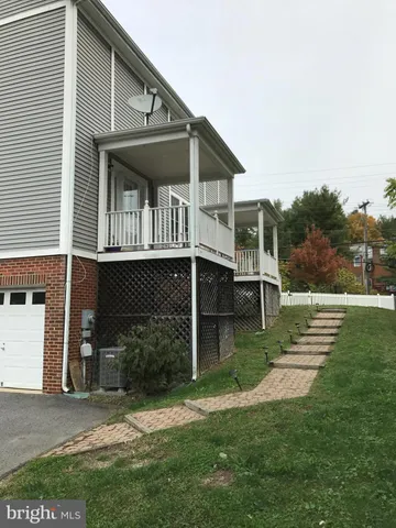 a view of house with a yard