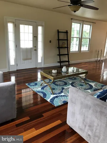 a living room with fireplace furniture and a window