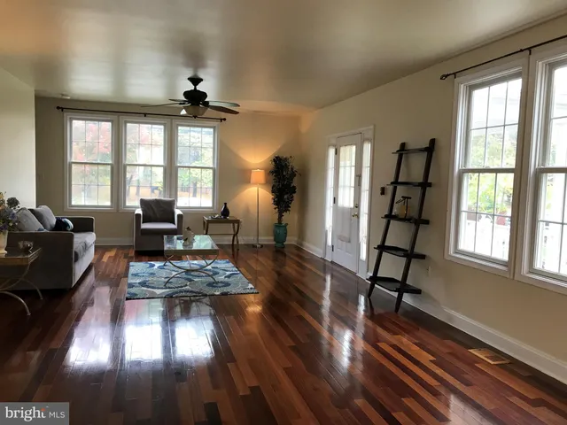a living room with furniture and a hard wood floor