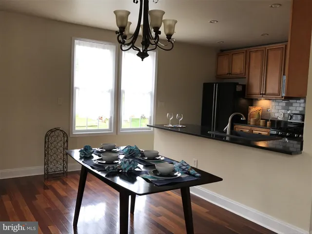 a table room with chairs and window