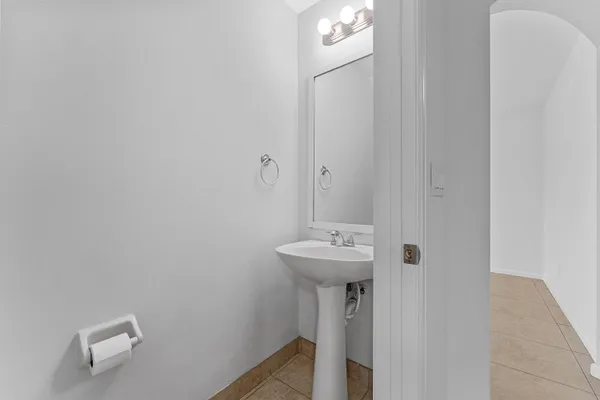 a bathroom with a sink a mirror and toilet