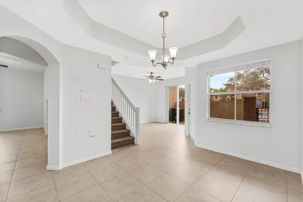 a view of a livingroom with wooden floor and stairs