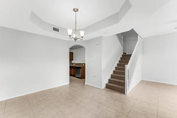 a view of a livingroom with a ceiling fan and staircase