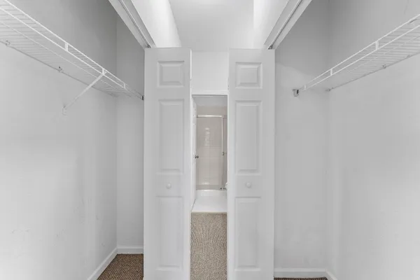 a bathroom with a granite countertop sink a mirror and a bathtub