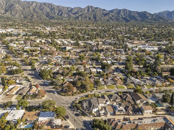 an aerial view of residential houses with city view
