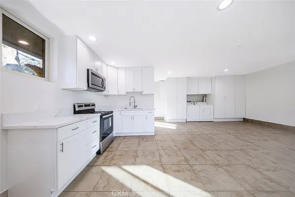 a kitchen with stainless steel appliances cabinets a sink and a stove