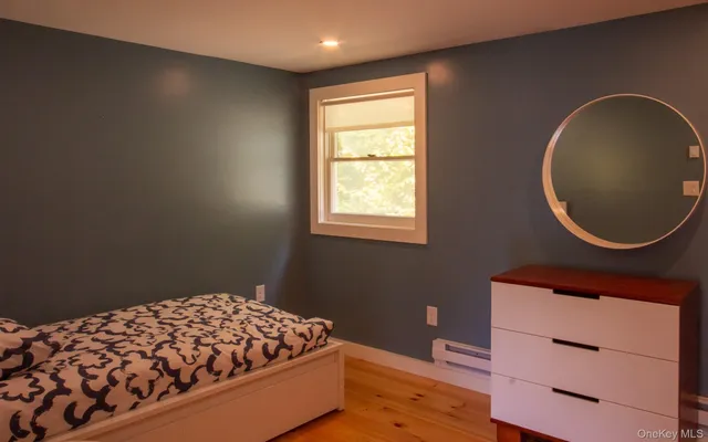 a bedroom with a bed and a dresser