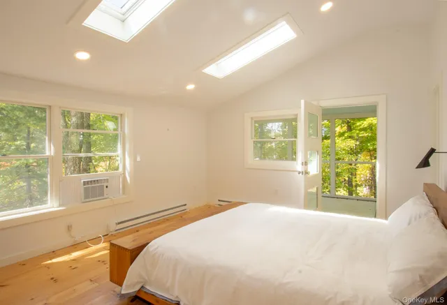 a bedroom with a bed and a large window