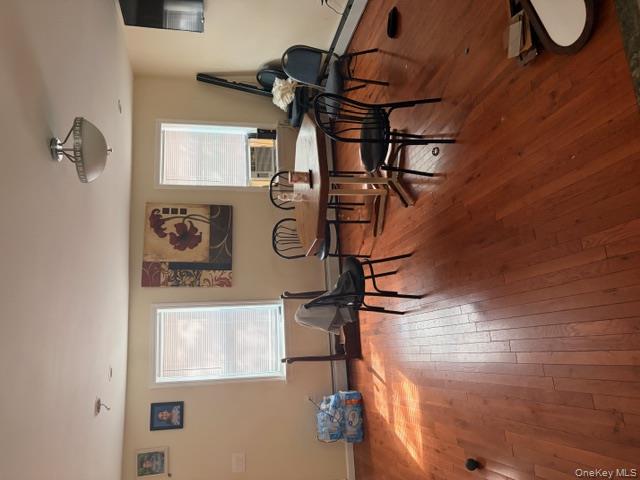 42 Hasbrouck Street Newburgh, NY 12550 - Photo 18 of 24 Dining space with light wood-style flooring, a baseboard heating unit, and cooling unit