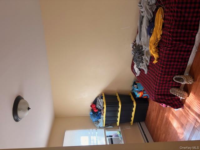 42 Hasbrouck Street Newburgh, NY 12550 - Photo 20 of 24 Bedroom featuring light wood-type flooring and a baseboard radiator