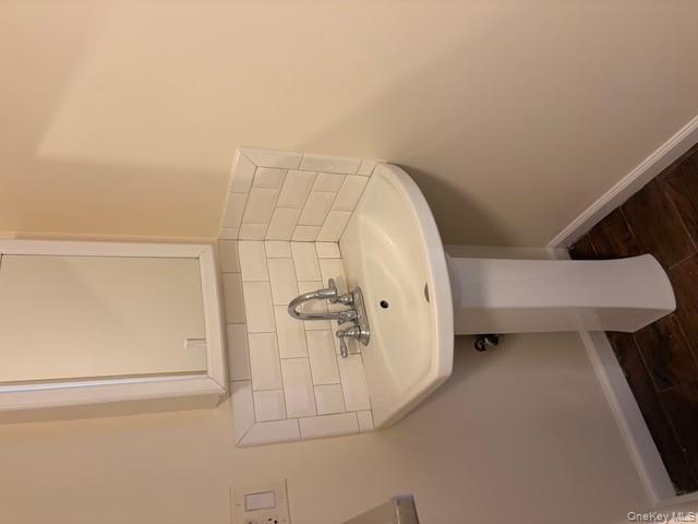 42 Hasbrouck Street Newburgh, NY 12550 - Photo 7 of 24 Bathroom featuring decorative backsplash and dark wood-style flooring