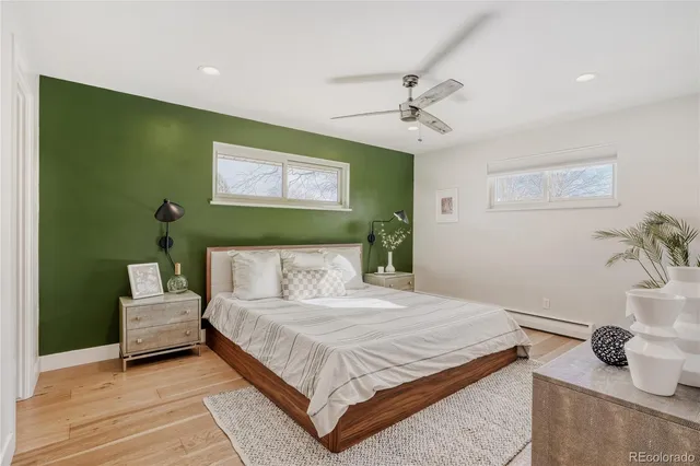 a bathroom with a granite countertop sink a toilet and a mirror