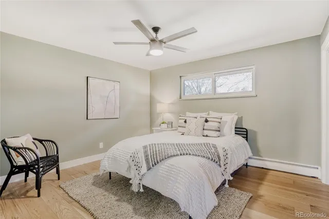 a bathroom with a toilet a sink a mirror a bathtub and vanity