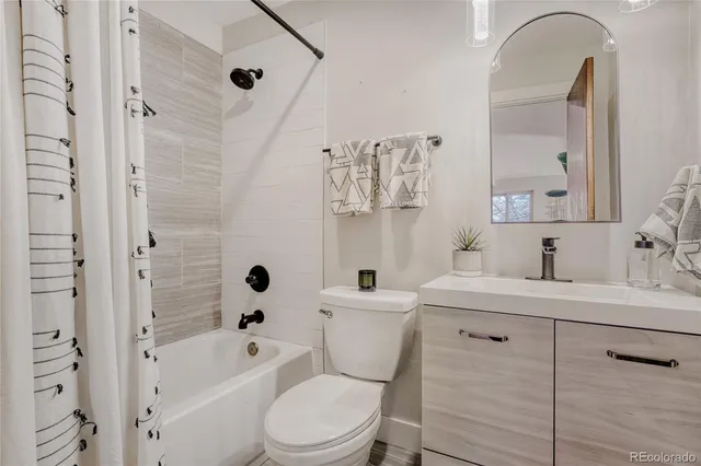 a hallway with white cabinets and window