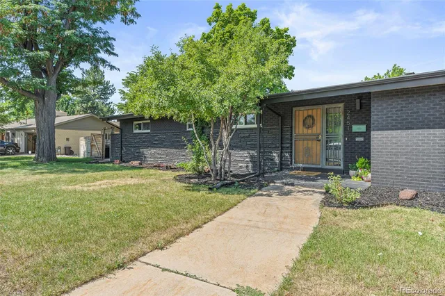 a living room with furniture a dining table and a potted plant