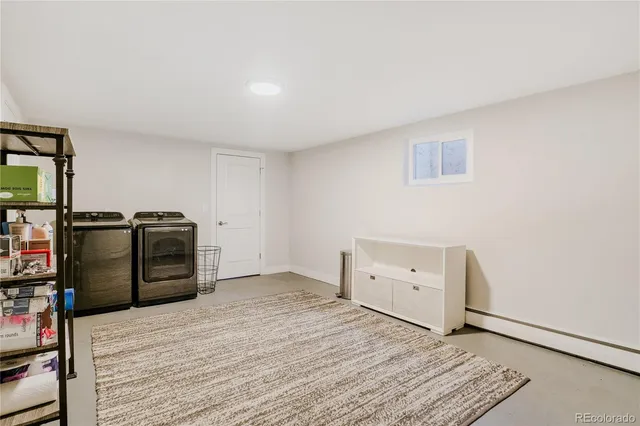 a view of a room with windows and furniture