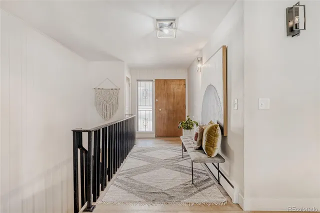 a view of entryway with wooden floor and windows
