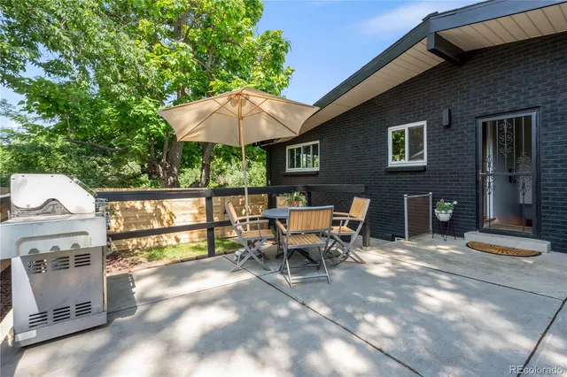 a patio with table and chairs