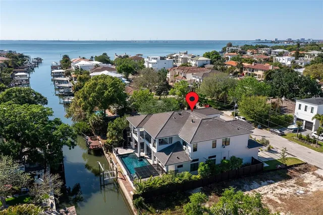 a bathroom with a granite countertop sink a toilet a mirror and a tub
