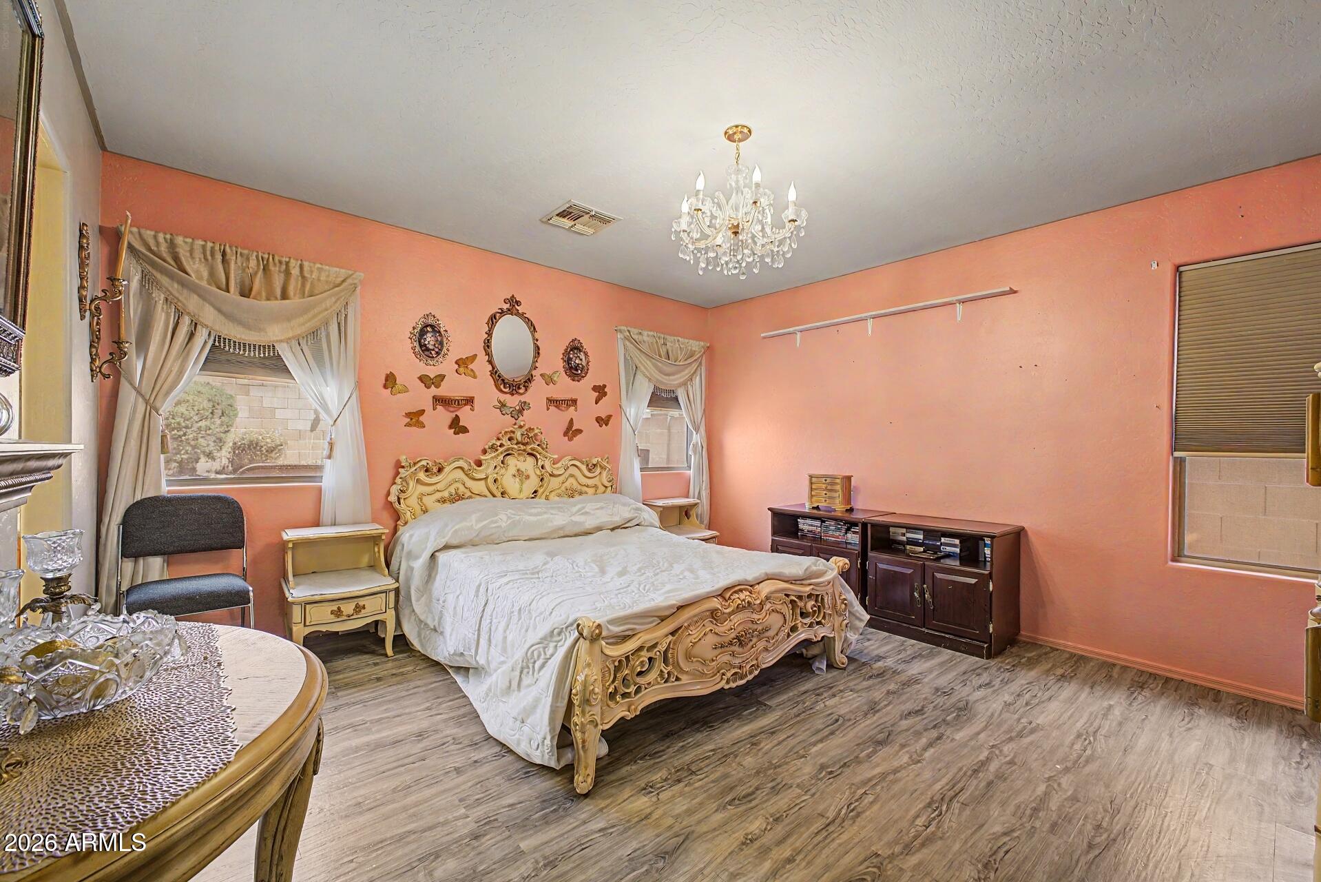 3691 South Conestoga Road Apache Junction, AZ 85119 - Photo 14 of 31 a bedroom with a bed and wooden floor