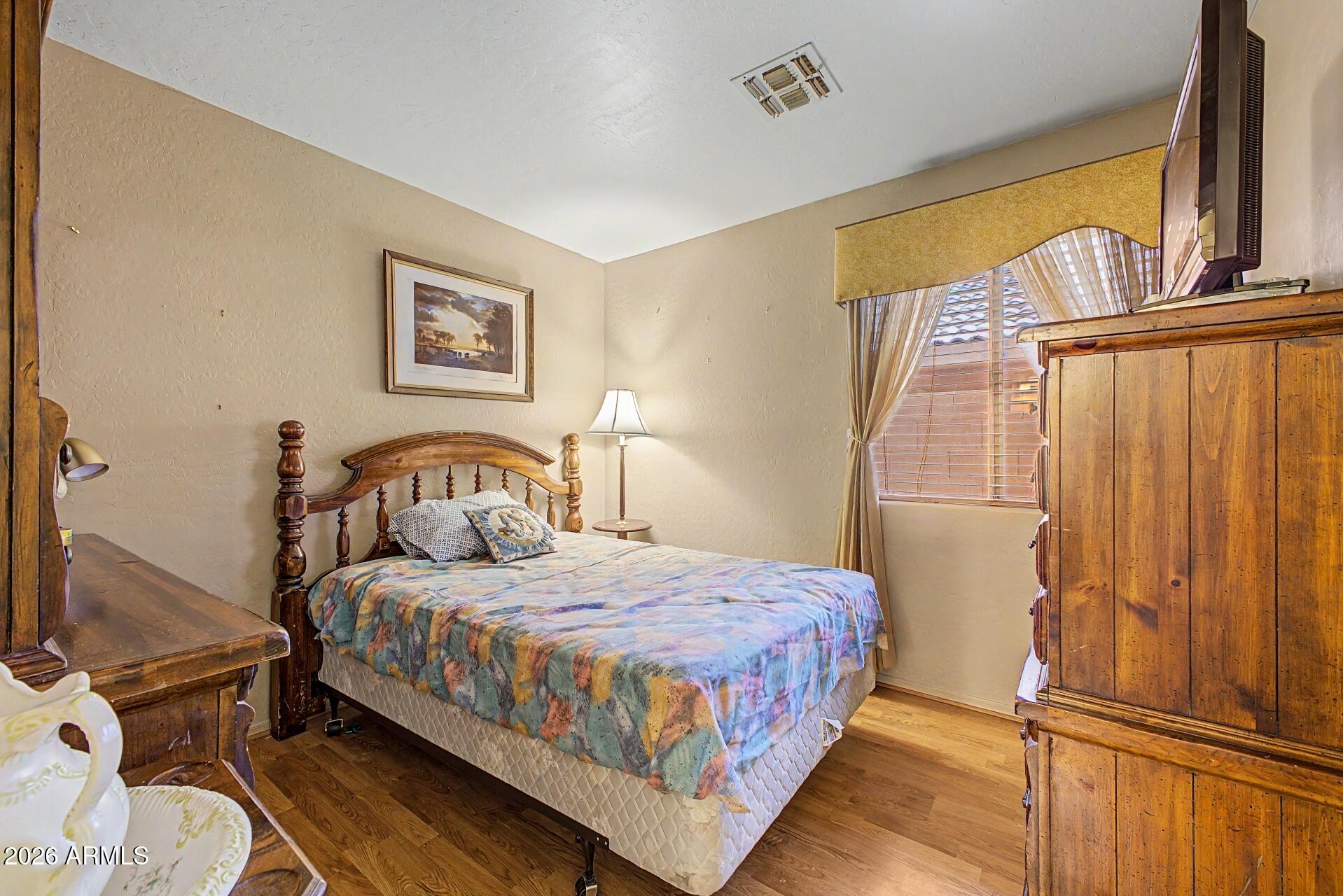 3691 South Conestoga Road Apache Junction, AZ 85119 - Photo 21 of 31 a bedroom with a bed and wooden floor