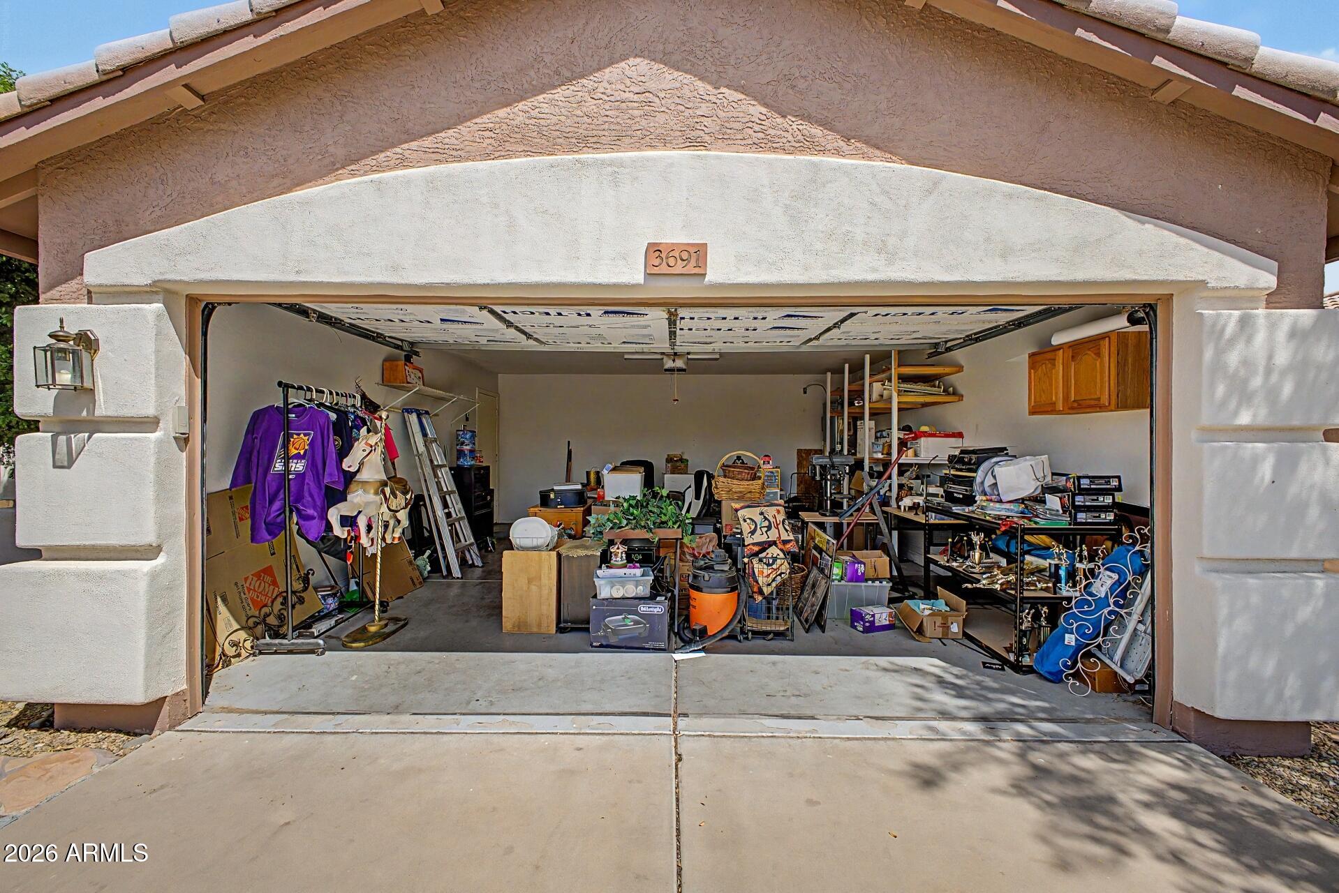 3691 South Conestoga Road Apache Junction, AZ 85119 - Photo 24 of 31 a view of a garage with a bike and car