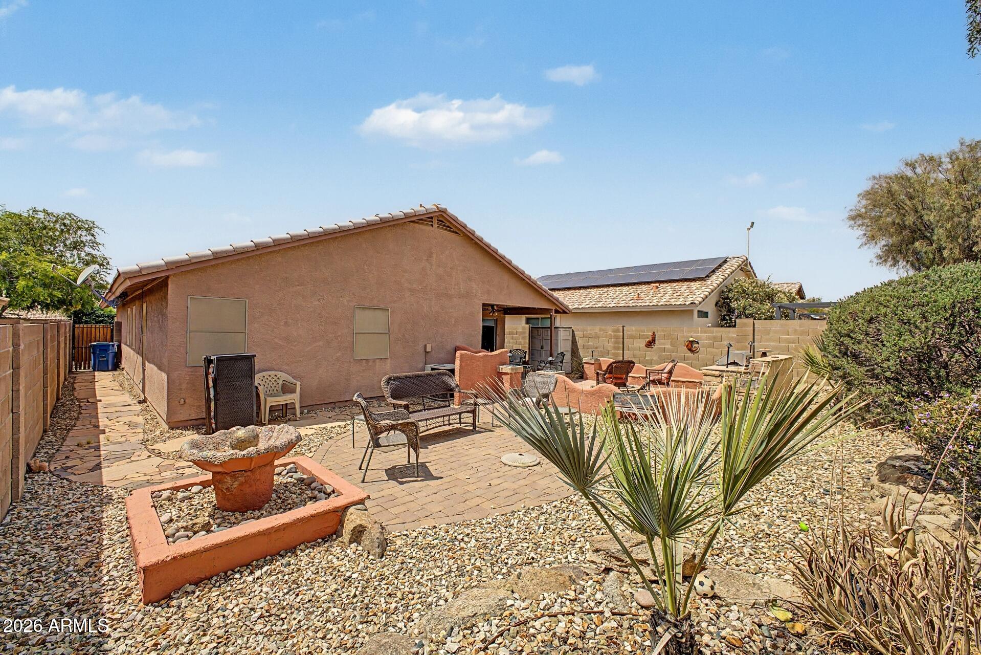 3691 South Conestoga Road Apache Junction, AZ 85119 - Photo 25 of 31 a view of a patio with couches and a table and chairs with wooden fence