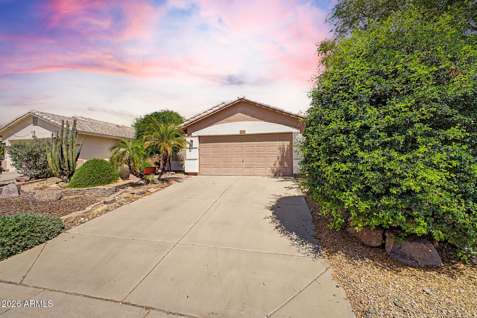 3691 South Conestoga Road Apache Junction, AZ 85119 - Photo 5 of 31 a front view of a house with a yard and potted plants