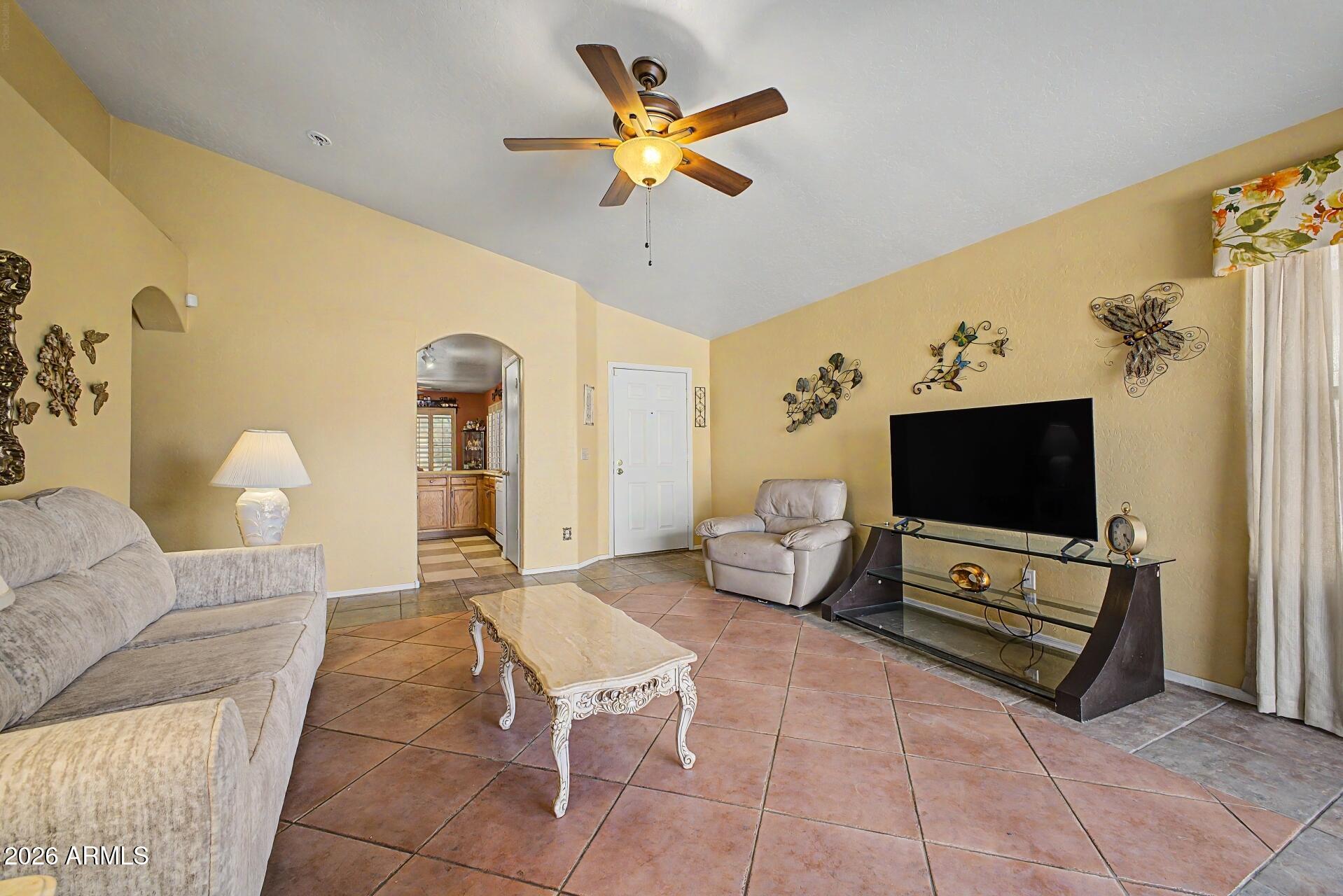 3691 South Conestoga Road Apache Junction, AZ 85119 - Photo 9 of 31 a living room with furniture and a flat screen tv