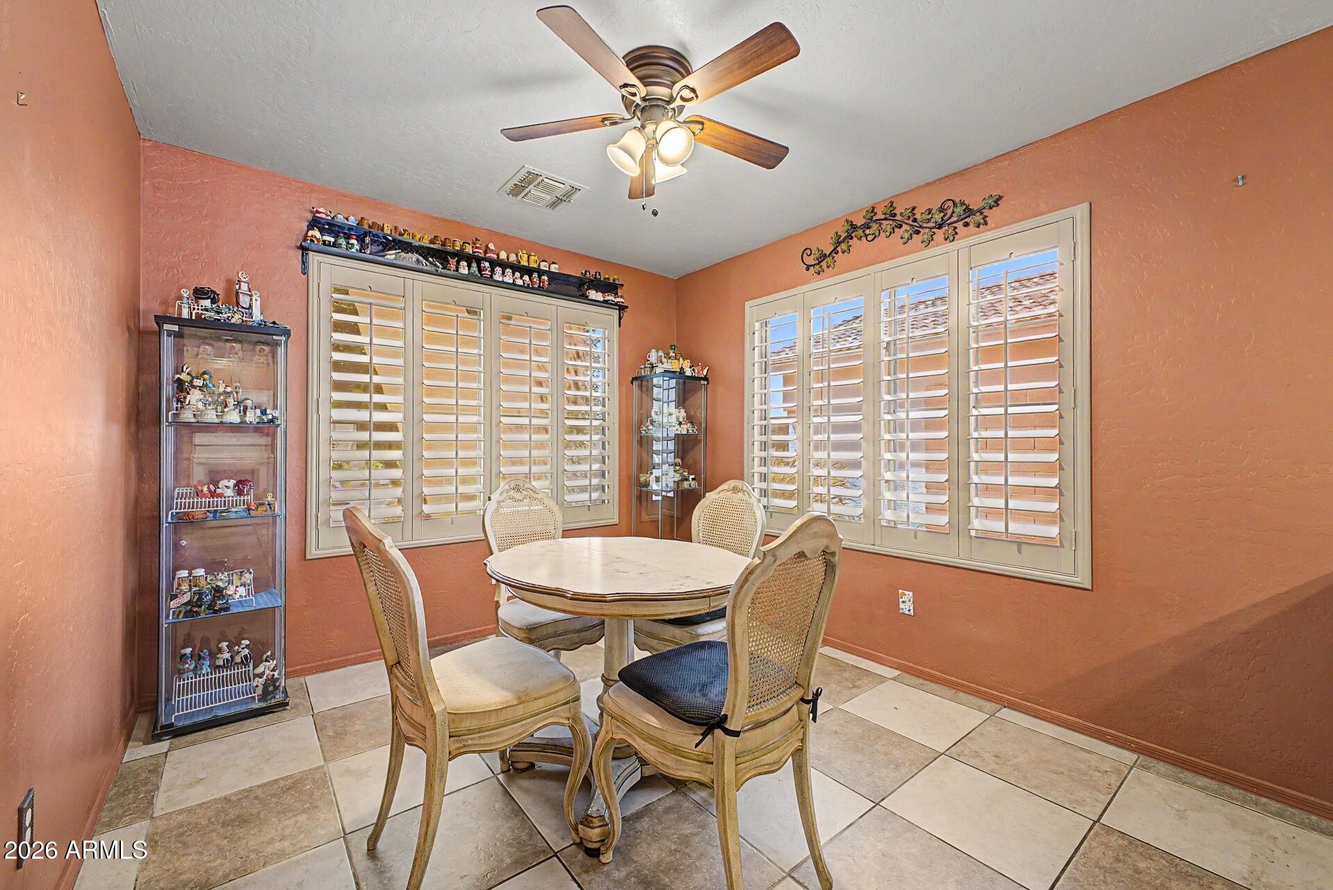 3691 South Conestoga Road Apache Junction, AZ 85119 - Photo 10 of 31 a view of a dining room with furniture and a window
