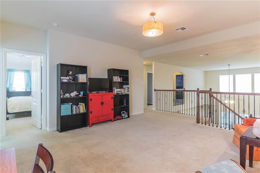 252 Pond View Pass Buda, TX 78610 - Photo 18 of 37 Sitting room with light colored carpet and an upstairs landing