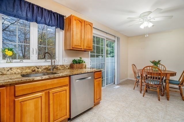 1 B Patriots Way, Unit B Sterling, MA 01564 - Photo 13 of 32 a kitchen with granite countertop wooden cabinets a dining table and chairs