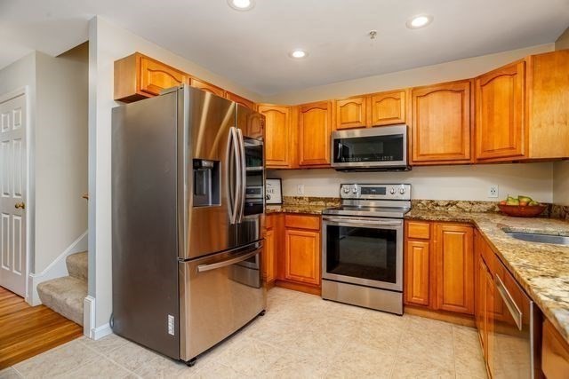 1 B Patriots Way, Unit B Sterling, MA 01564 - Photo 14 of 32 a kitchen with stainless steel appliances granite countertop a refrigerator stove and microwave