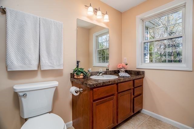 1 B Patriots Way, Unit B Sterling, MA 01564 - Photo 22 of 32 a bathroom with a granite countertop toilet sink and mirror