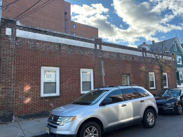 a front view of a house with parking space