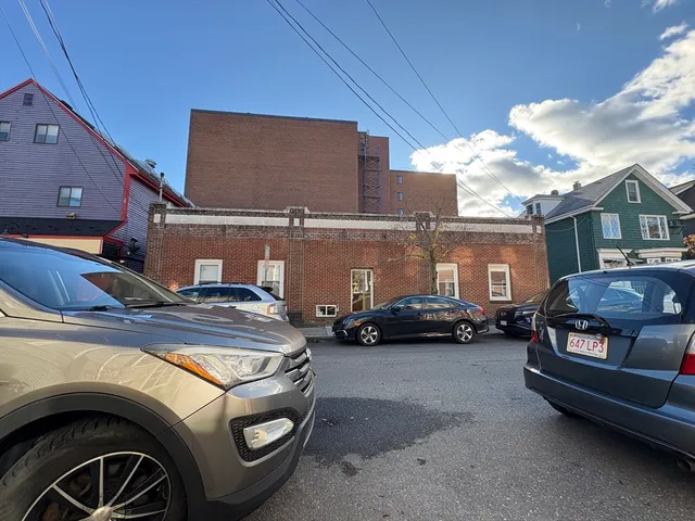 a view of a car parked in back of a house