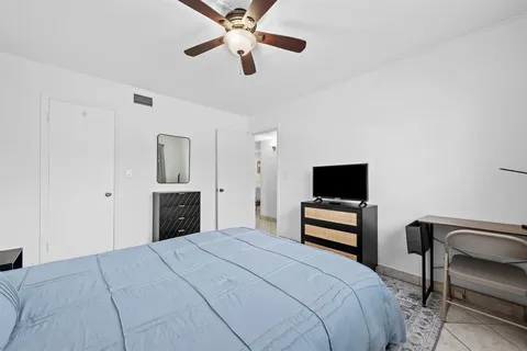 a bedroom with a bed and a tv