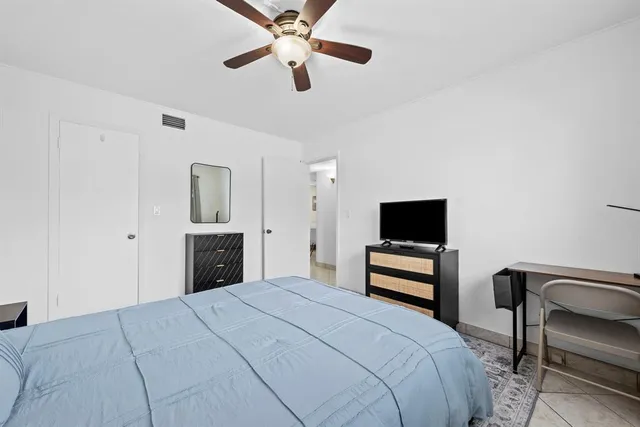 a bedroom with a bed and a tv