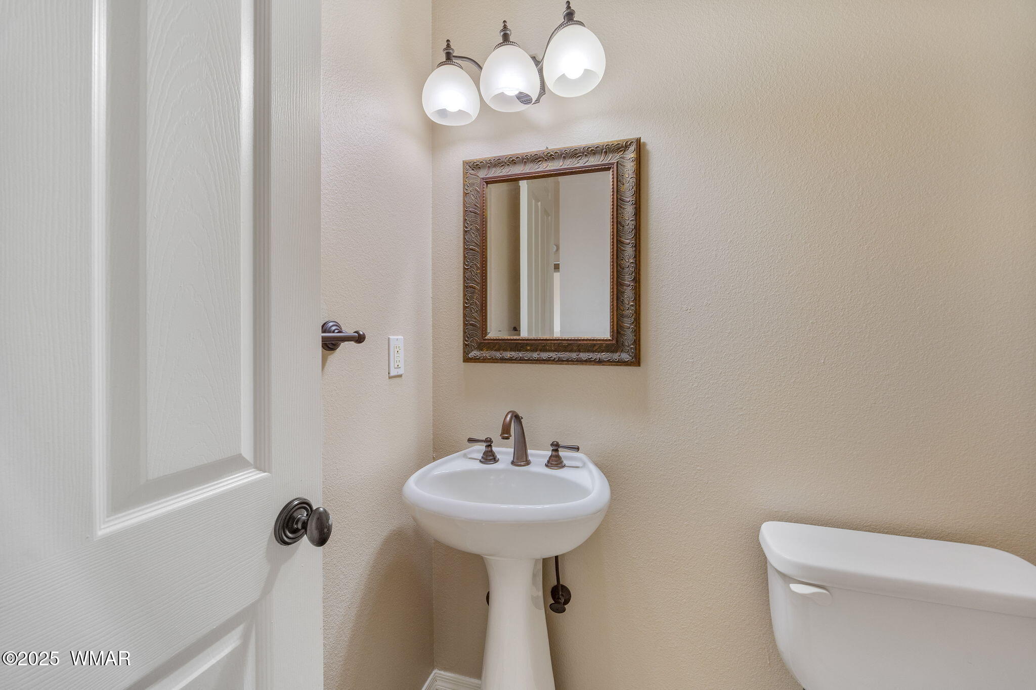 1058 East Adams Street Snowflake, AZ 85937 - Photo 12 of 37 a bathroom with a toilet a sink and mirror