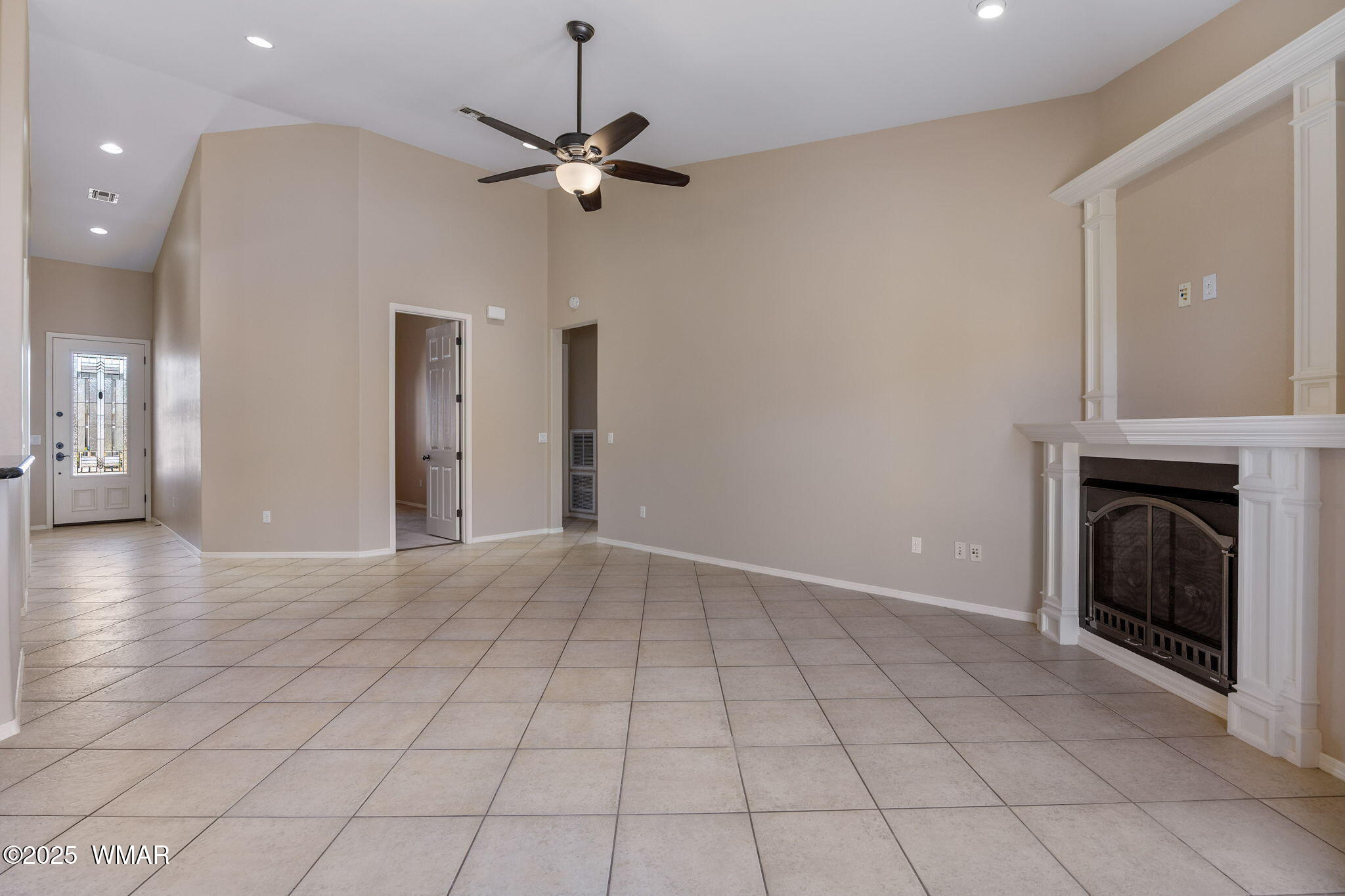 1058 East Adams Street Snowflake, AZ 85937 - Photo 13 of 37 a view of an empty room with chandelier fan and fire place