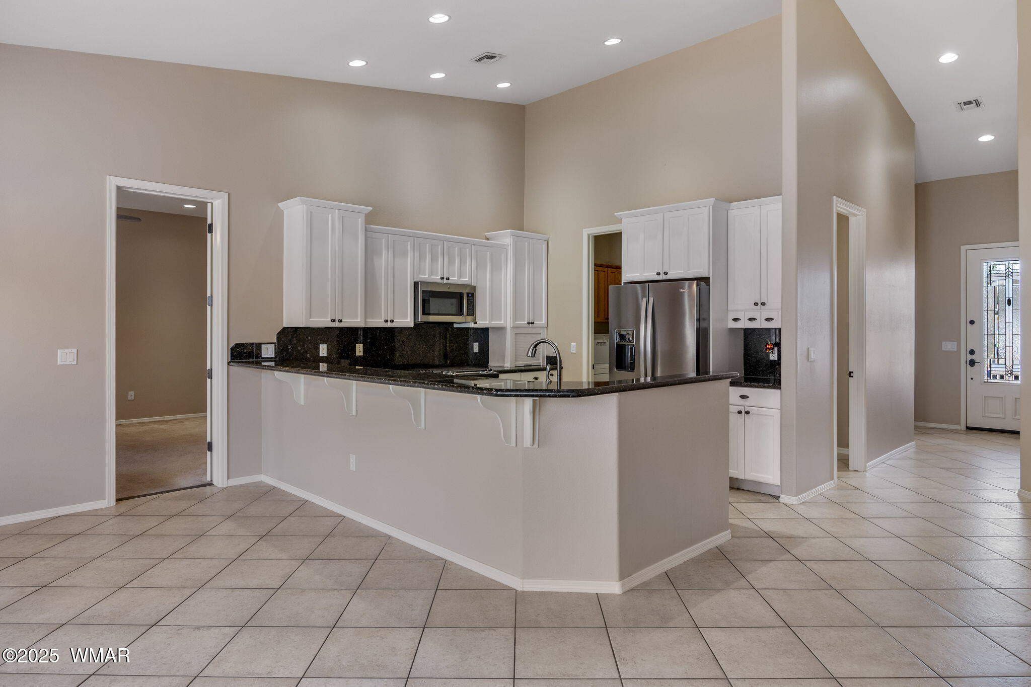 1058 East Adams Street Snowflake, AZ 85937 - Photo 4 of 37 a kitchen with stainless steel appliances a refrigerator sink and microwave
