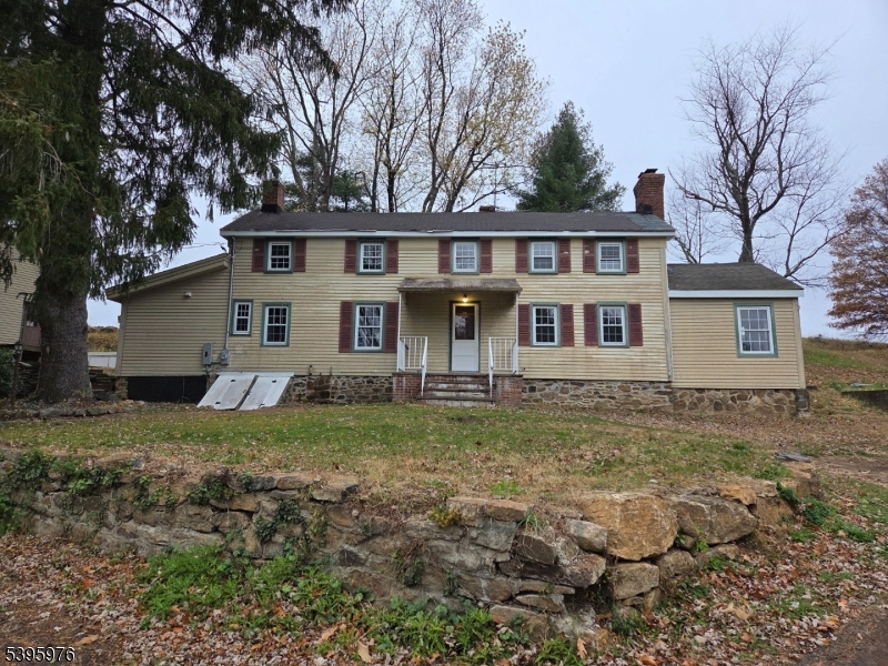 a view of a yard in front of a house with large tree