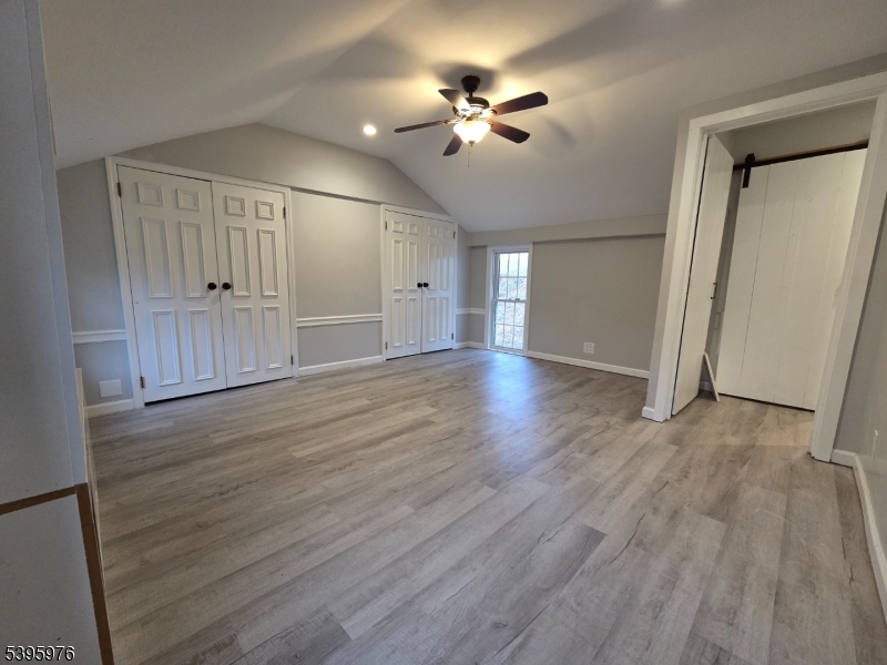 97 Fairmount Road East Califon, NJ 07830 - Photo 28 of 32 a view of an empty room with wooden floor and a ceiling fan