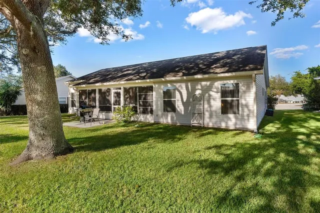 a view of a house with a backyard porch and sitting area