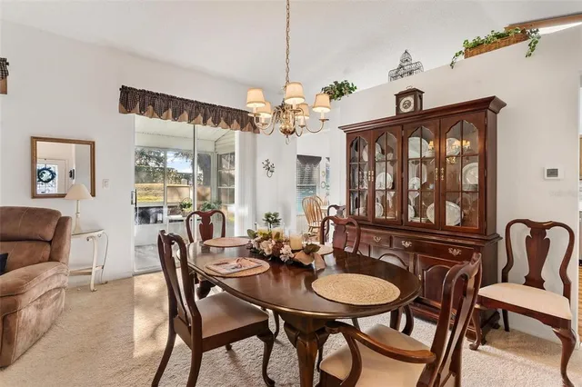 a view of a a dining room with furniture window and wooden floor