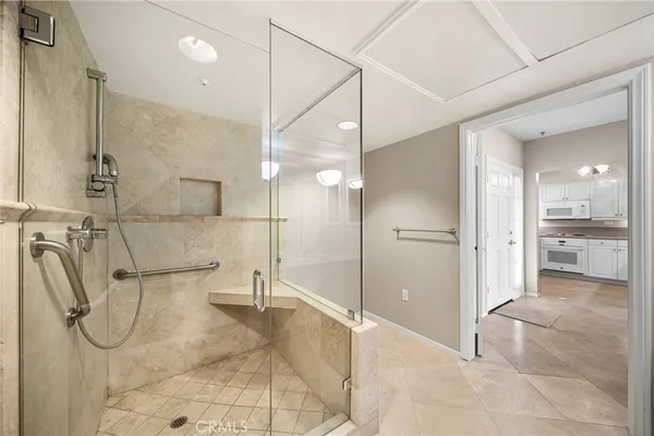 a bathroom with a glass shower door and a shower